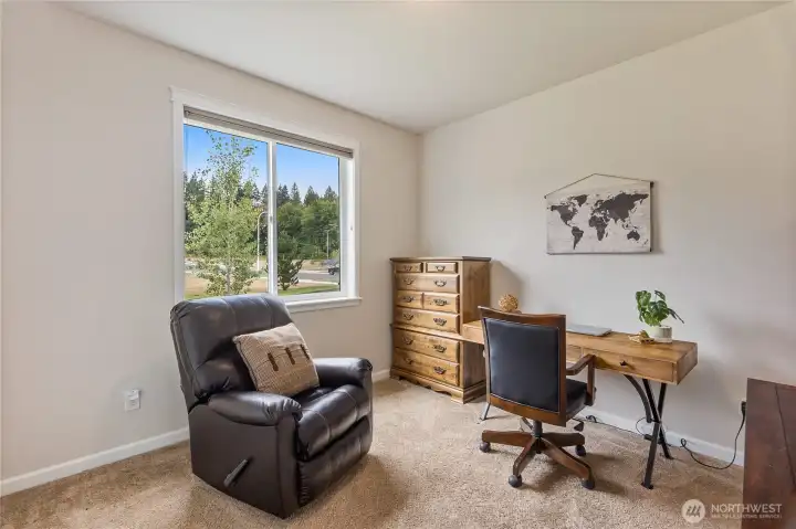 This multi=purpose room can be used as an office or a third bedroom.  Up-down shades clothe a window that looks out onto the resource parcel.