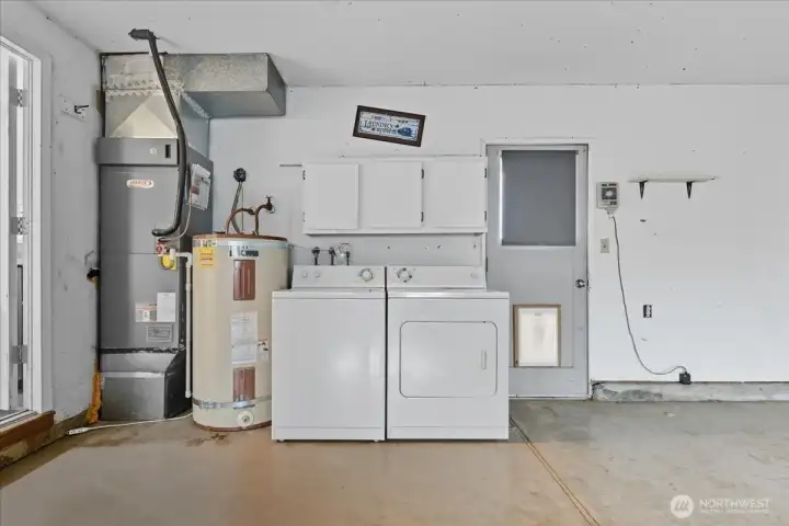 Garage with Laundry and Door to Backyard