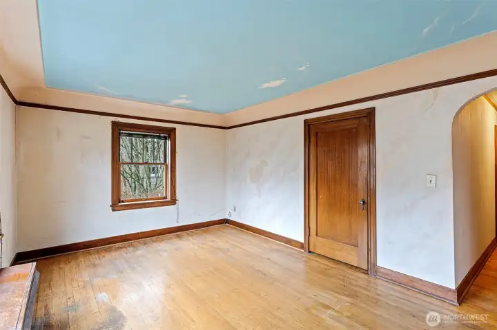 A welcoming space full of vintage charm—original mahogany trim, arched entryways, warm natural light, and a walk-in closet of its own.