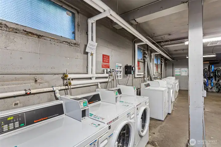 Just beyond the bike storage, a spacious laundry room with a lounge area and a full wall of modern, WiFi-operated machines makes laundry day a little more civilized.