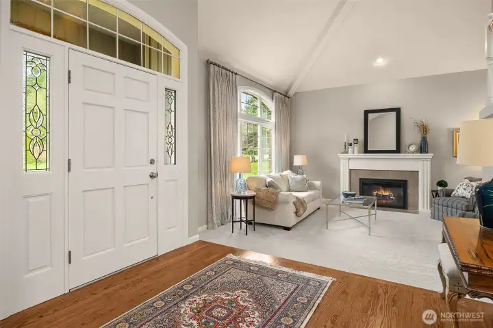 A welcoming formal living room w/ gas fireplace awaits just beyond the grand foyer