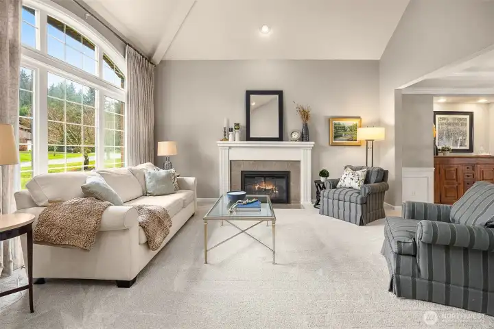 A welcoming formal living room w/ gas fireplace awaits just beyond the grand foyer