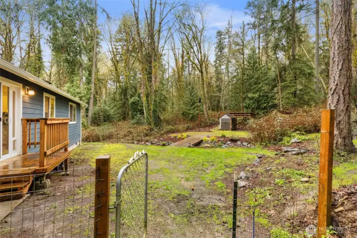 Fenced yard for pets, but loads of acreage outside the fence. Including a road to access from the back.