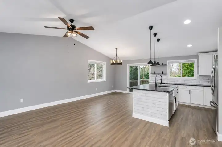 This AI generated photo demonstrates the living room, dining room and kitchen with no furniture. Sellers have just move their furniture from the home.