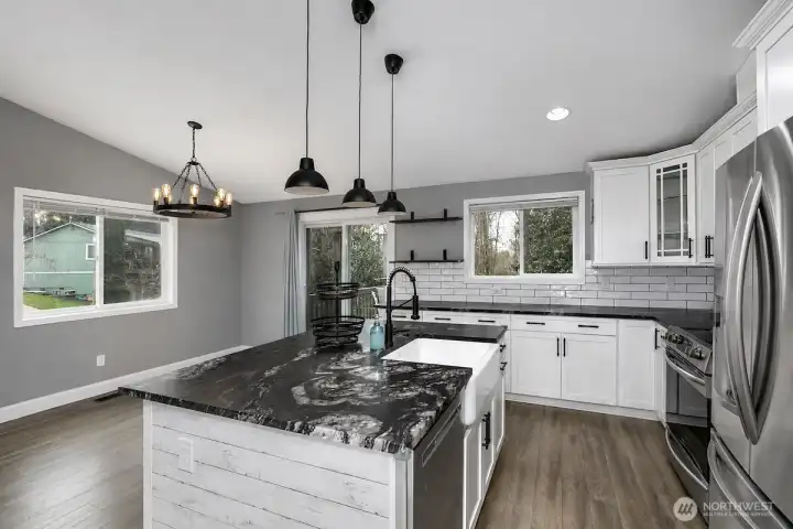 This AI generated photo demonstrates the kitchen & dining room with no furniture. Sellers have just move their furniture from the home.