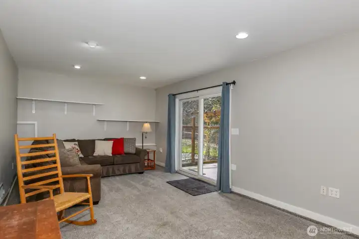 Rec room on the lower level with slider to lower deck and the fully fenced back yard