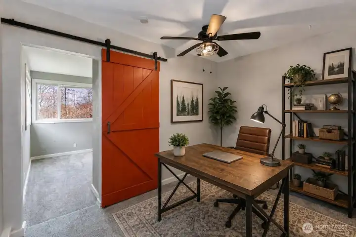 This AI digitally staged photo demonstrates the bonus open office space downstairs. Sellers have just move their furniture from the home.