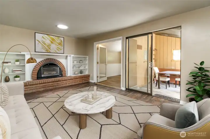 Family room with fireplace, patio access, and attached den. Virtually staged. Family room with fireplace, patio access, and attached den. Virtually staged.
