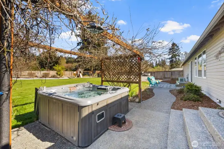 Stunning hot tub surrounded by Wysteria. a custom built Pergola, and a Shower head to rinse off before you come back into your bedroom!  Perfect for those late night evenings under the stars!