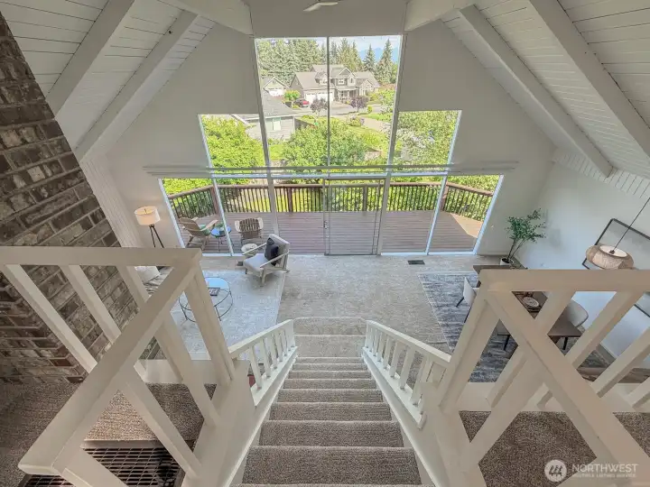 Loft area looking down to expansive windows