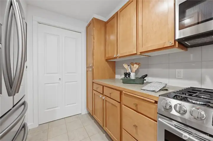 The kitchen leads to the pantry storage & stack wash & dryer behind the bi-fold door for convenience. The kitchen leads to the pantry storage & stack wash & dryer behind the bi-fold door for convenience.