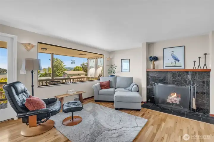 A warm wood-burning fireplace anchors the space.