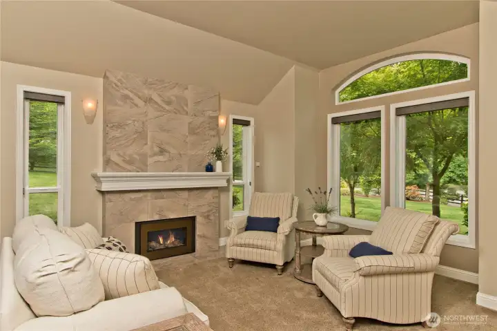 Additional living room with beautifully tiled gas fireplace.