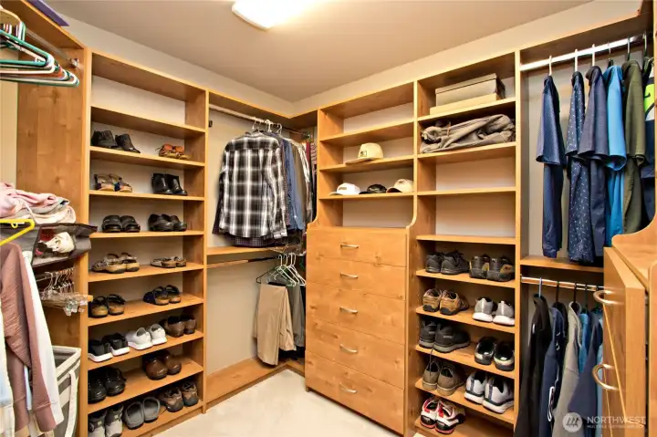 Primary bedroom walk in closet with built-ins