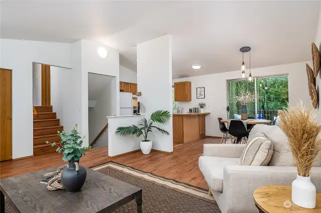 The living room is large and open, with vaulted ceilings and lots of light. A short flight of stairs leads to the upper bedroom level.