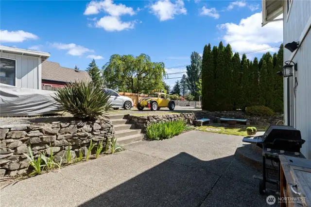 Large back patio  with stairs to the shed and tons of parking.