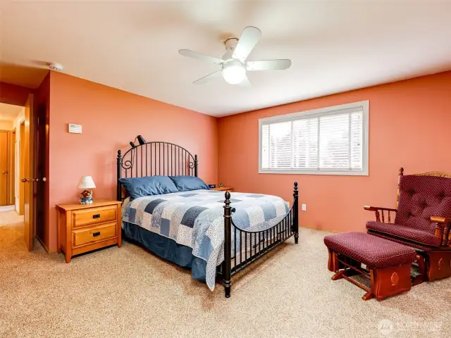 Generous primary suite located near peaceful backyard oasis.