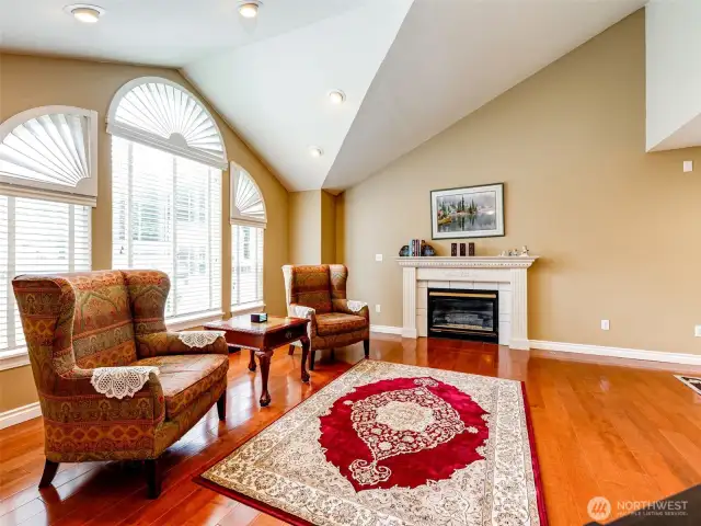 Living room with hardwood floors and gas fireplace.
