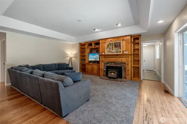 Family room with wood burning fireplace.