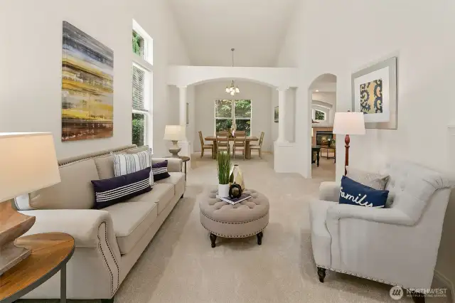 Formal living room with soaring vaulted ceiling. Interior has been freshly painted.