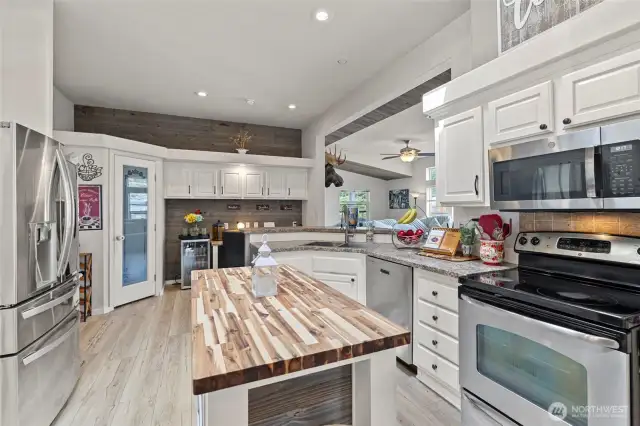 Light, bright, chef's kitchen with stainless appliances and pantry