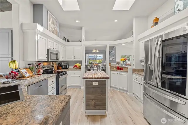 Light, bright, chef's kitchen with skylights, stainless appliances, pantry, and eat-in counter space