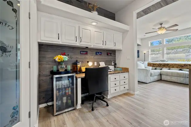 Pantry and built in office area with additional storage, flowing into the family room