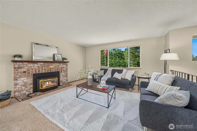 Spacious living room on the upper level with gas fireplace.