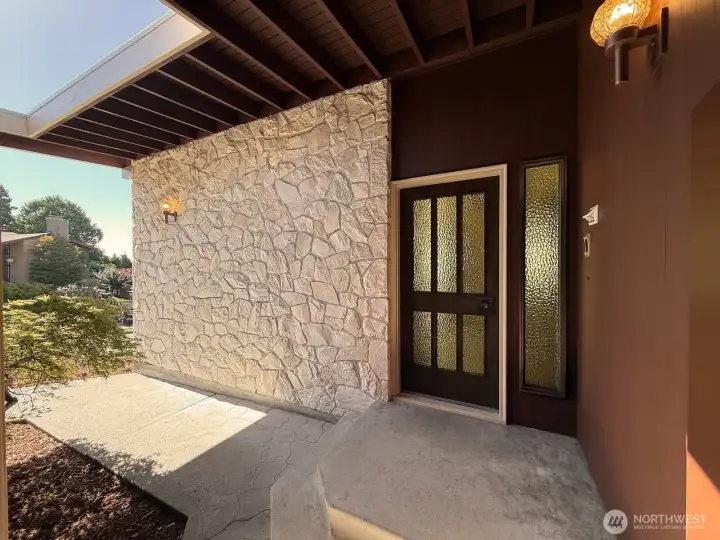 Handpicked Montana Travertine stone clads the front and breezeway entry of this very cool residence.
