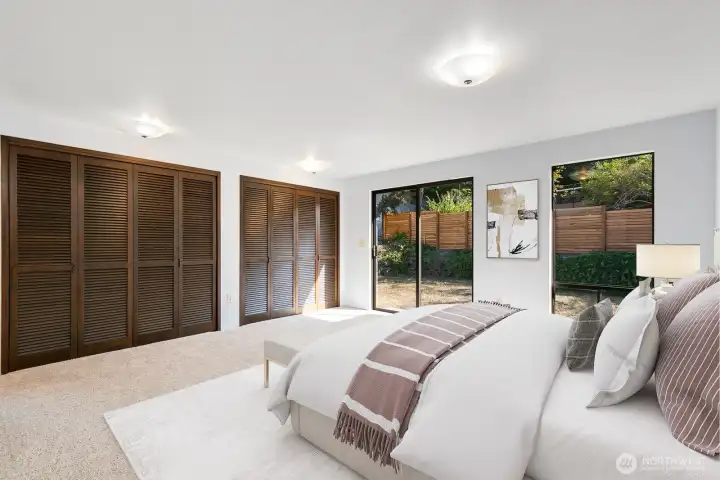 Spacious Primary bedroom with sliders to the back yard.  Two large, side by side closets