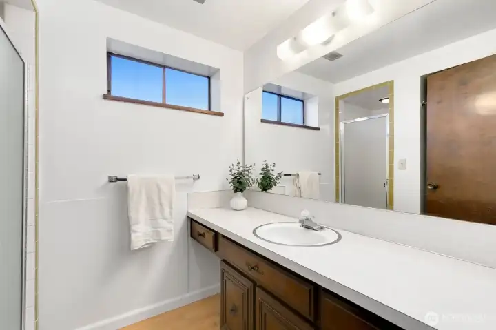 Lower level 3/4 bathroom with walk-in, tiled shower.