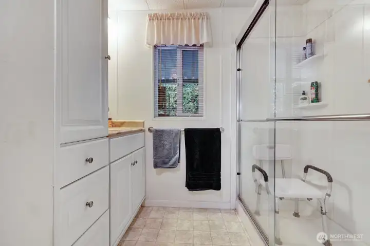 Guest bath with step in shower for your comfort and safety. Updated cabinetry. Single vanity. Plenty of storage space for all your bathroom necessities