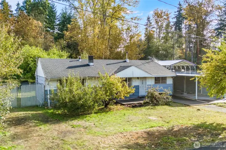 The front of the home also has fruit trees and a large yard area.