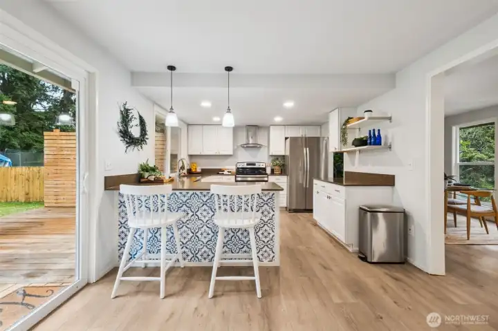The kitchen shines with a remodel in 2020; granite countertops, stainless steel appliances, and cabinetry. Ample prep space and a breakfast bar makes cooking and entertaining a joy.