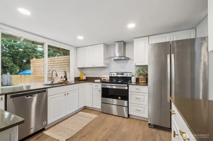 The large windows provide lots of natural light and open views to the large, fully fenced back yard.