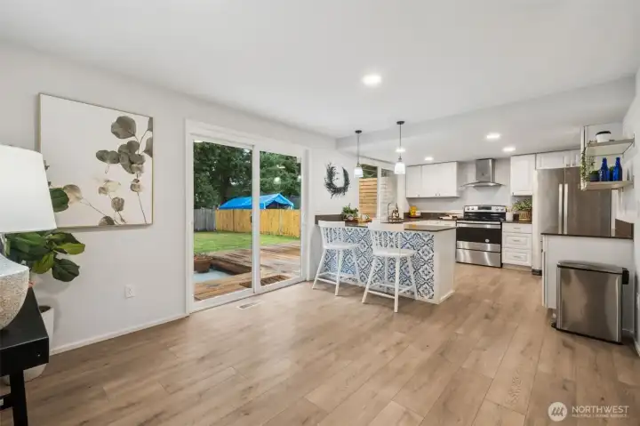 A welcoming eating area off the kitchen features a slider leading to the patio and deck, extending your living space outdoors. It’s ideal for casual meals, summer gatherings, and enjoying the fully fenced backyard.