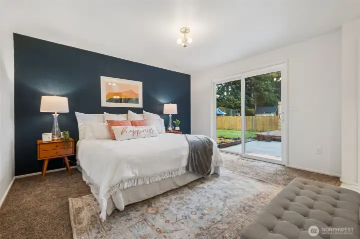 Retreat to a spacious Primary bedroom with walk in closet and EnSuite offering comfort, privacy, and room to unwind. This King Sized bed easily fits in this large Suite and enjoys a slider out to the back yard. Hot tub, anyone?