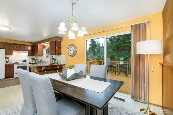 Dining room, with a slider of the back to a large  cedar deck runs length of the house