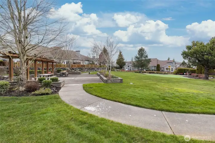Quiet community greenspace featuring a picnic area and well-manicured grounds, managed entirely by the HOA