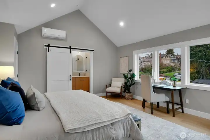 Primary bedroom with vaulted ceilings