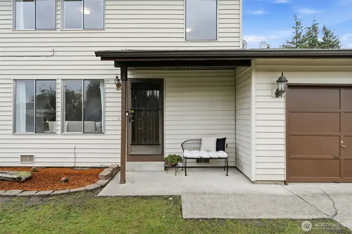 Covered front entry with seating area, enjoy morning coffee, or greet guests in comfort.