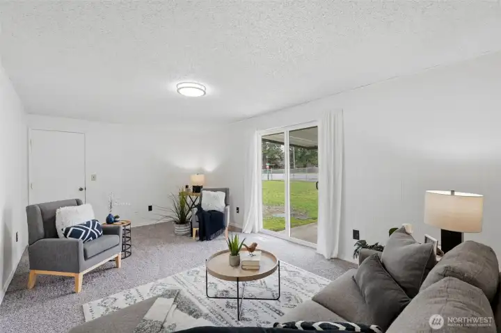 Spacious family room with sliding door to the backyard, great natural light, and functional flow for everyday living.