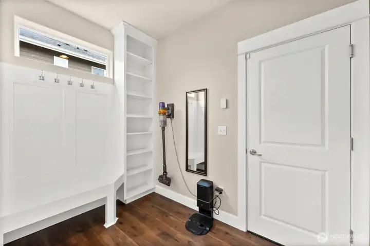 mudroom with built-in bench and shelving