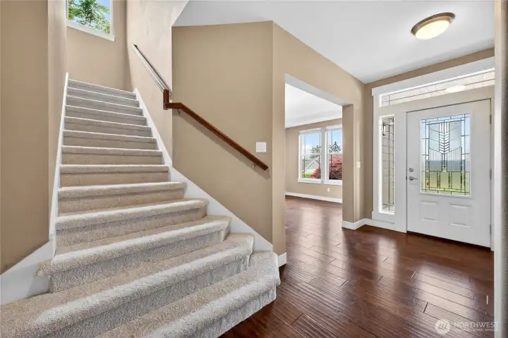 Additional highlights include new carpet, crisp white trim, energy-efficient solar panels, all appliances included, soaring ceilings, and beautifully wood-trimmed windows.