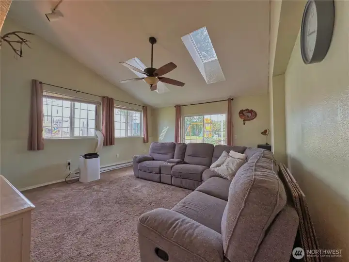 Family room with vaulted ceilings and skylight