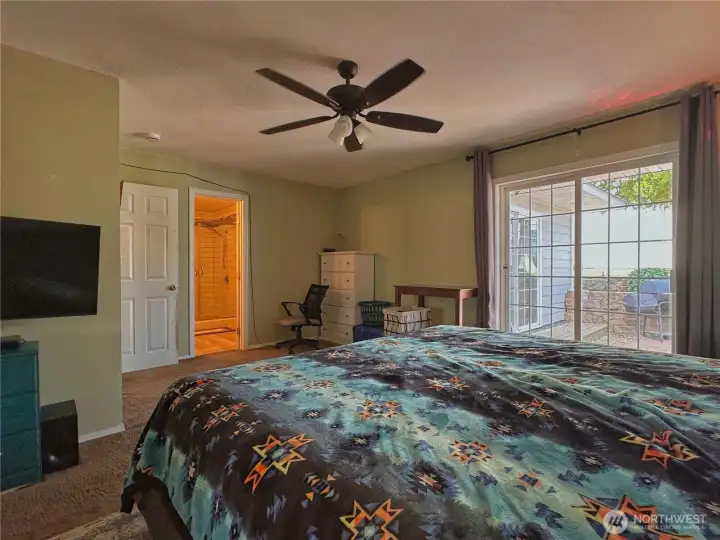 Sliding door in primary bedroom leads to patio