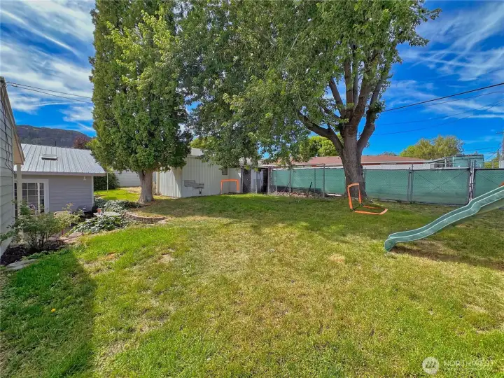 Fenced and private backyard with detached single car garage and alley access