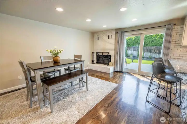 Dining room featuring a cozy wood fireplace Dining room featuring a cozy wood fireplace