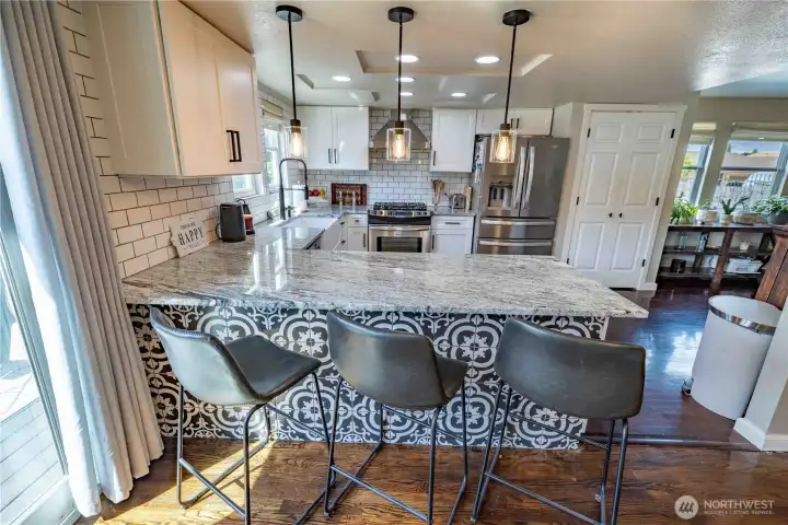 Large island with seating and pendant lighting Large island with seating and pendant lighting