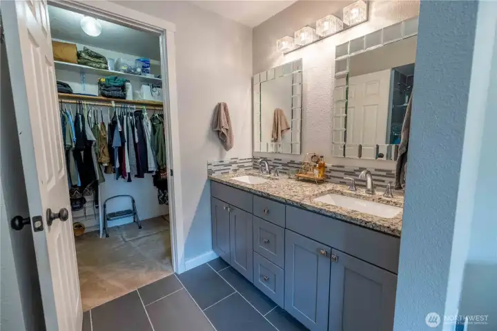 Updated primary bathroom with dual sink vanity and heated floors Updated primary bathroom with dual sink vanity and heated floors